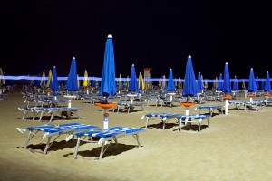 Beaches on the Italian Riviera buzz though the night under electric lights