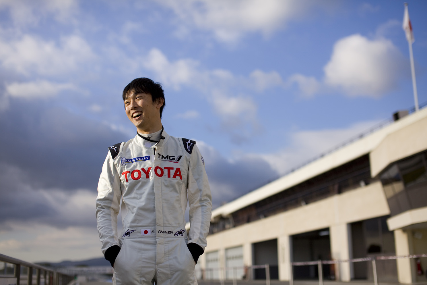 Driver Kazuki Nakajima chats with media before taking the car out