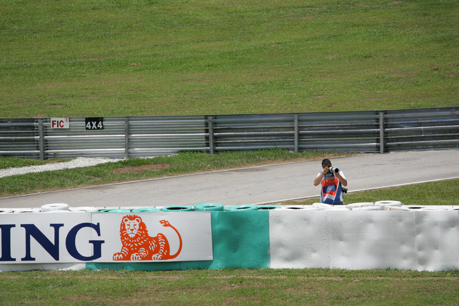 A photographer shoots trackside at the Malasian Grand Prix