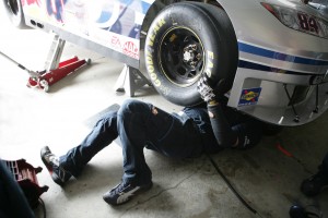 A Red Bull Team Member works on the car