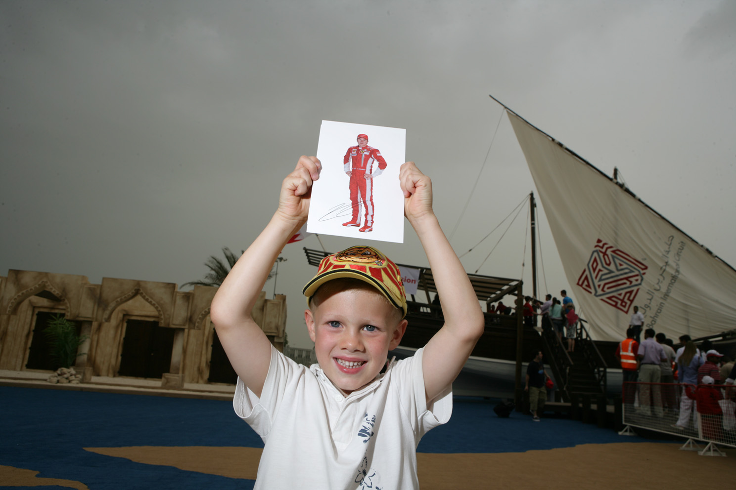 A young Kimi Räikkönen fan celebrates receiving a signed photo.