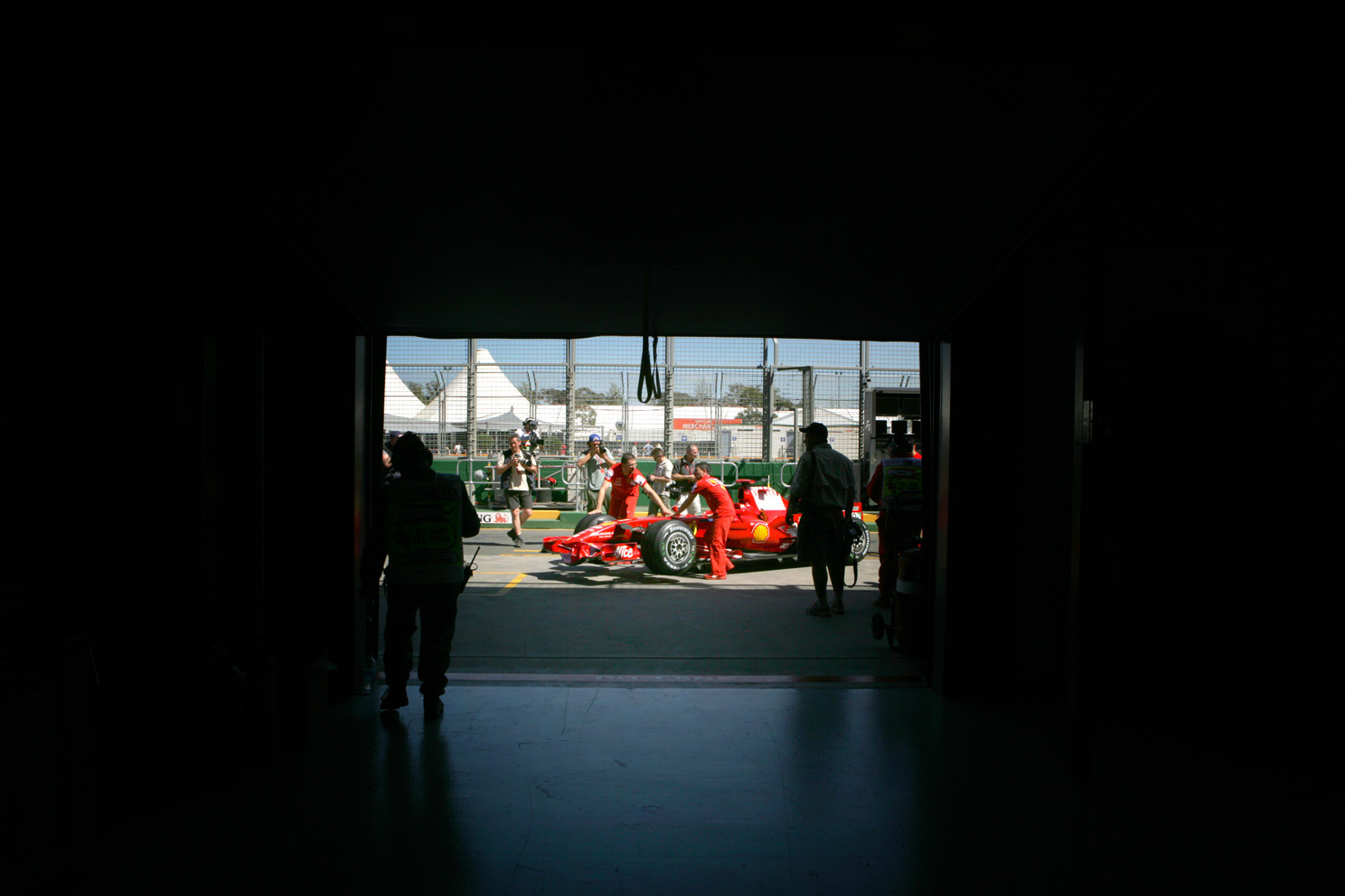 The Ferrari team pushes one of the cars to the scrutineering at the Melbourne Grand Prix 2008