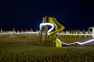 Beaches on the Italian Riviera buzz though the night under electric lights