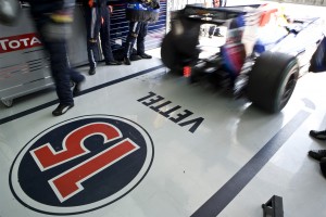 Vettels Red Bull Racing car zooms out of the garage