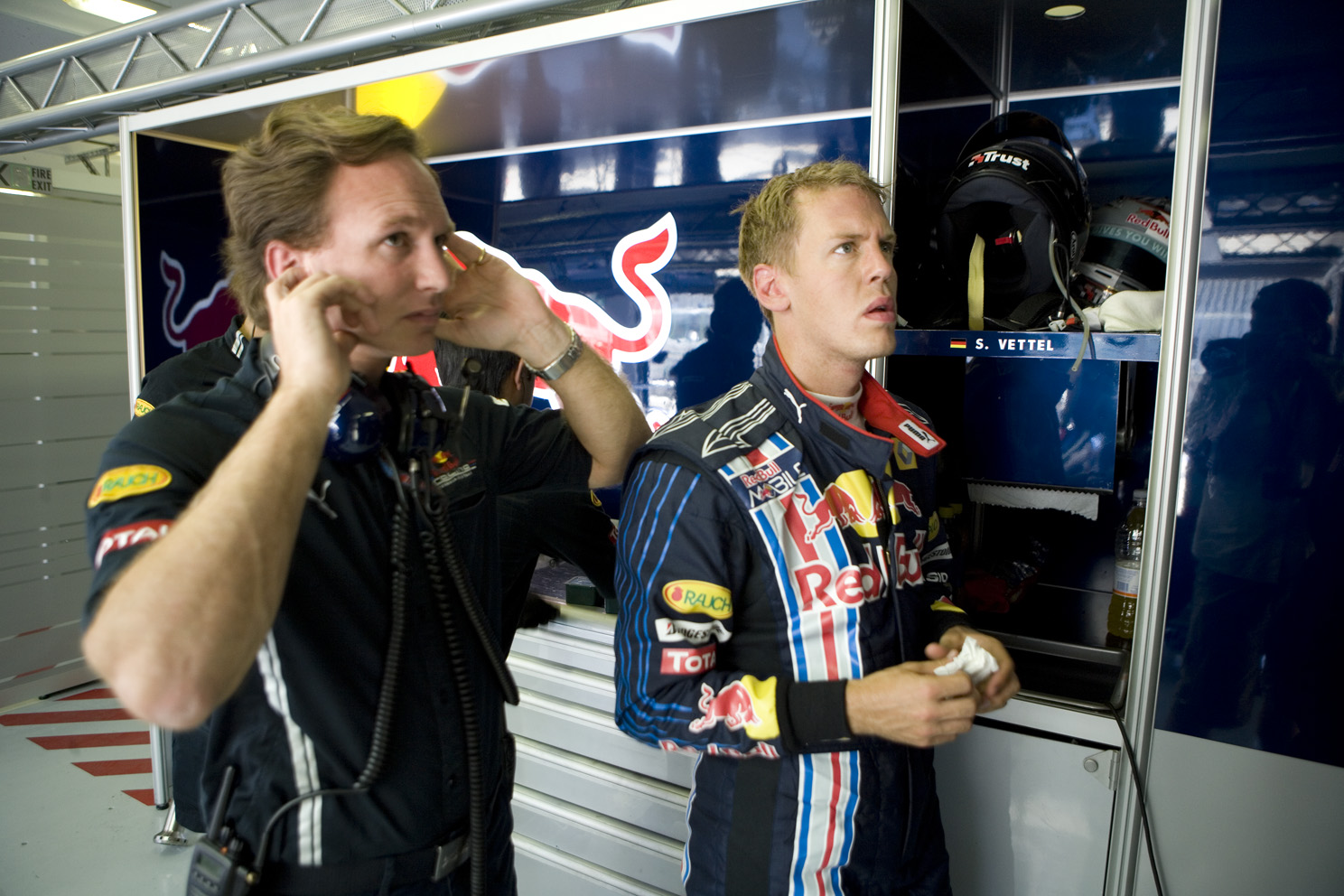team principle Christian Horner and Sebastian Vettel watching the qualifying session on the garage TV's