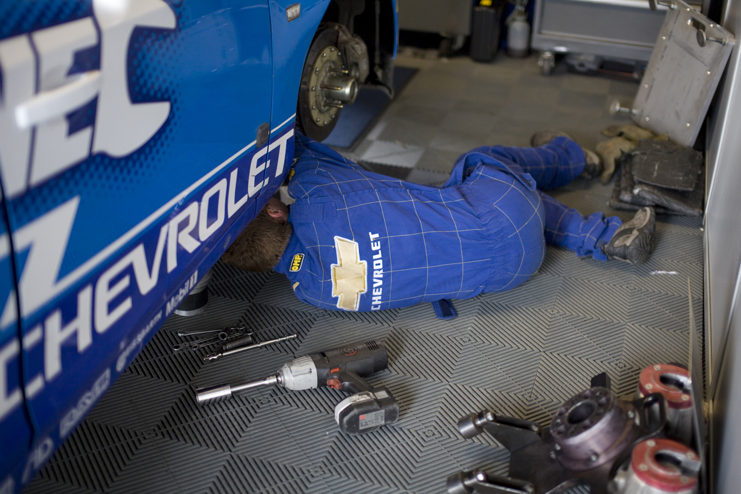A Chevrolet mechanic works on Jason's car.
