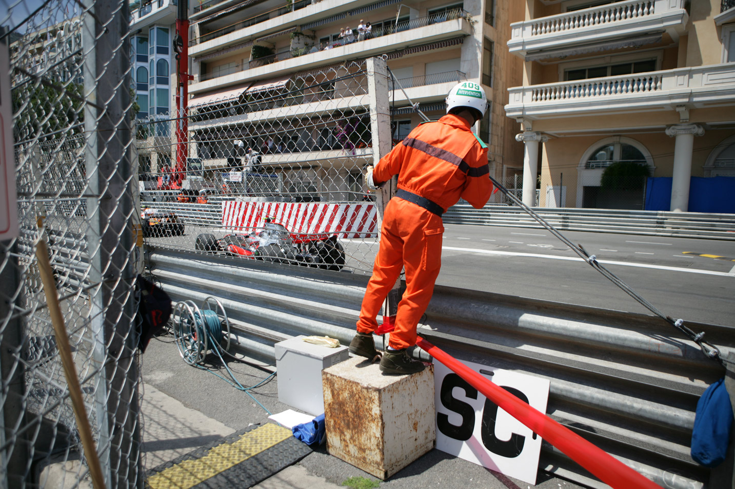 A marshall gets a good look at the cars during the Monaco Grand Prix