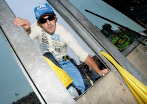 Fernando Alonso climbs over the pit wall