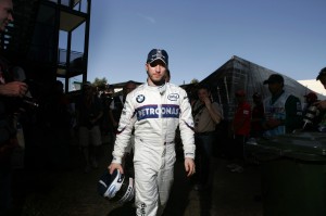 Nick Heidfeld walks through the pit lane at the Australian Grand Prix